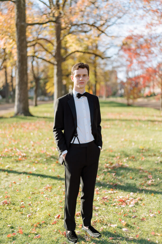 Groom in a stylish black tuxedo outside