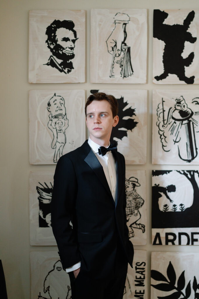 classic portrait of a groom in a black tuxedo looking off with pride and distinguish.