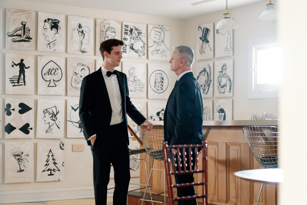 Photo of a groom and his father sharing a quiet moment together before the ceremony