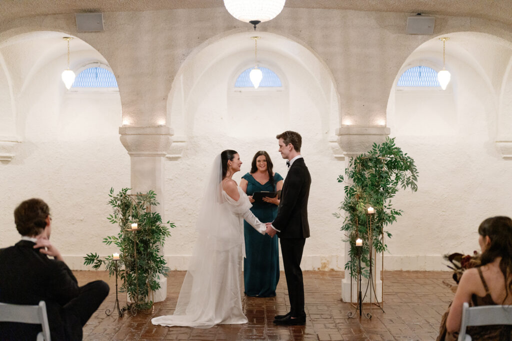 bride and groom holding hands during their ceremony